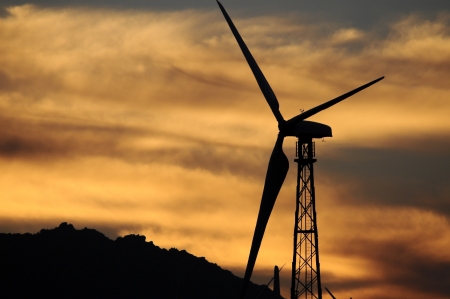 Silhouette of a wind turbine during sunset.  Palm Springs, California.