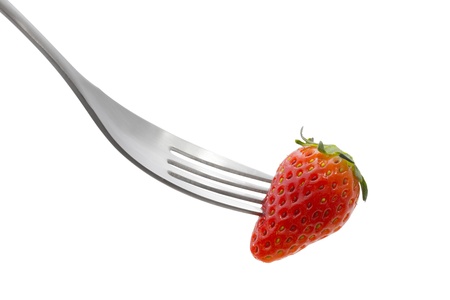 Speared strawberry with a fork on a white backgroundの写真素材