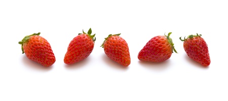 strawberries in a row isolated on whiteの写真素材