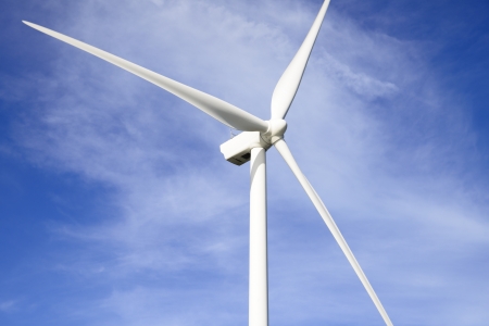 A wind turbine against a blue sky 