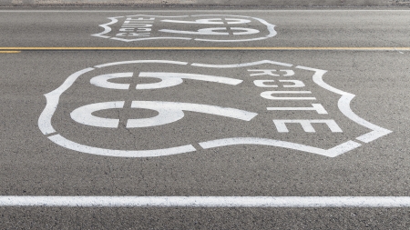 Historic route 66 sign painted on a desert highway in California の写真素材