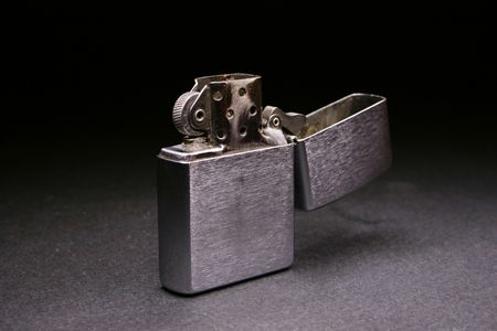 opened lighter on gray black backgroundの写真素材