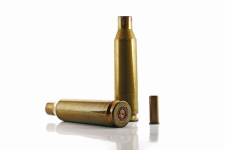 three used bullet casings isolated on whiteの写真素材
