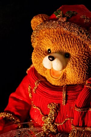 teddy bear in winter, on black backgroundの写真素材