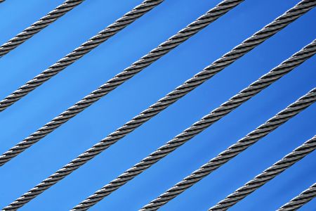 abstract twisted steel wires on blue sky backgroundの写真素材