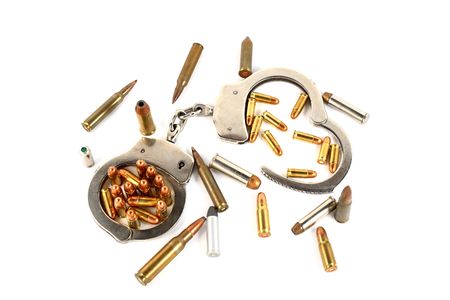 handcuffs and bullets isolated on whiteの写真素材