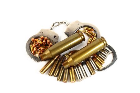 handcuffs and bullets isolated on whiteの写真素材