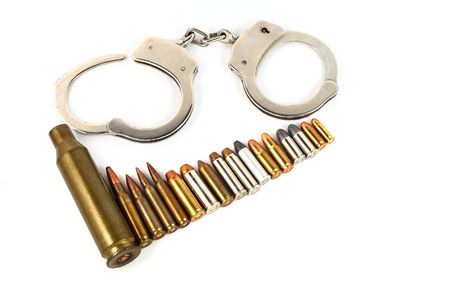handcuffs and bullets isolated on whiteの写真素材