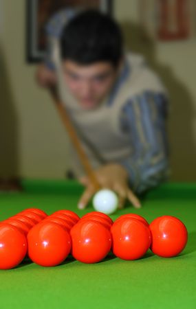 Snooker player hitting a ball, shallow depth of fieldの写真素材