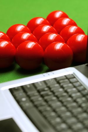 snooker balls and laptop on green surface, shallow depth of fieldの写真素材