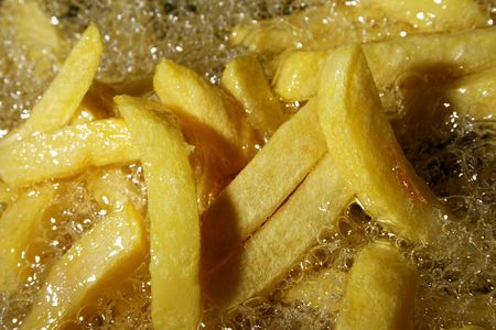french fries - chips baking in oilの写真素材