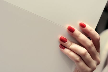 fancy female hand holding foldable whitepaperの写真素材