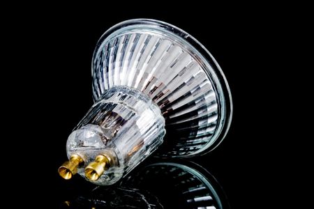 small halogen lightbulb isolated on black, with reflectionの写真素材
