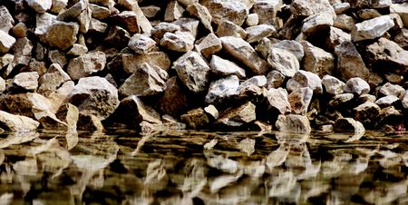 rocks with a reflection in the waterの写真素材