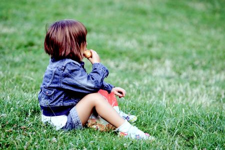 child having meal in the meadowの写真素材