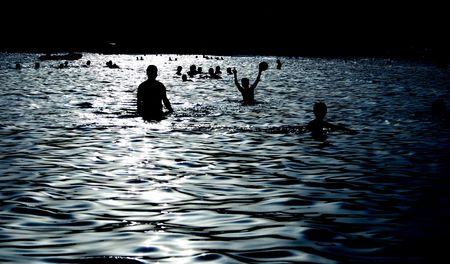 people silhouettes having fun in the seaの写真素材