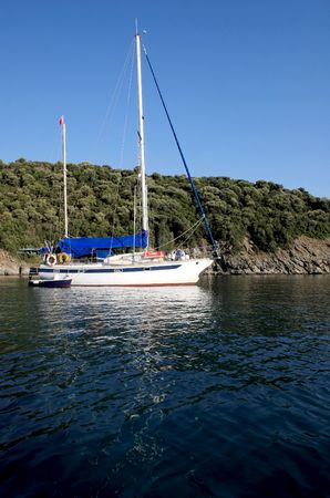 yacht anchored near one of the greek islandsの写真素材