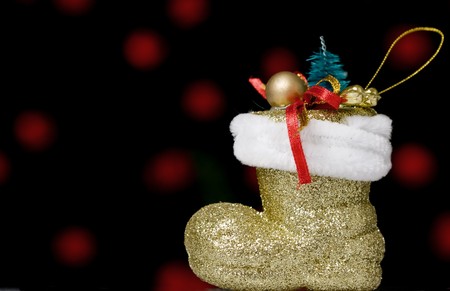 christmas shoe, with defocused red light bulbs in the backgroundの写真素材