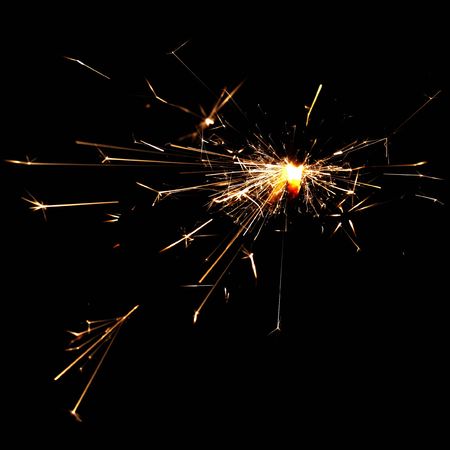 burning christmas spakrler isolated on black backgroundの写真素材