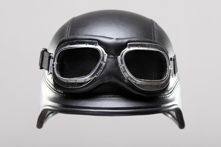 old-style us army motorcycle helmet with goggles, on gray backgroundの写真素材