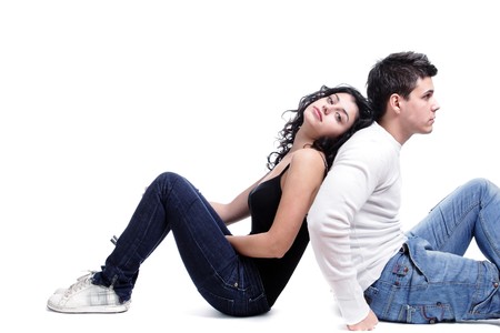 portrait of a young couple, sitting on white backgroundの写真素材