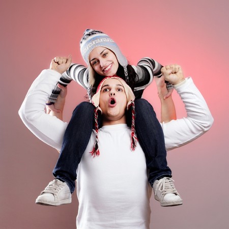 attractive young winter couple having some fun