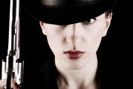 elegant lady in black holding a revolver の写真素材