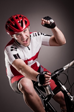 fully equipped cyclist riding a bicycleの写真素材