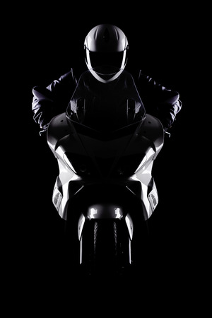 motorist on a motorcycle against black backgroundの写真素材