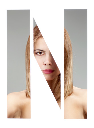 girl portrait behind the letter "N"の写真素材