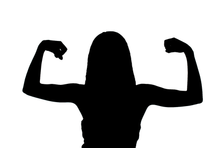silhouette of a girl showing her musclesの写真素材