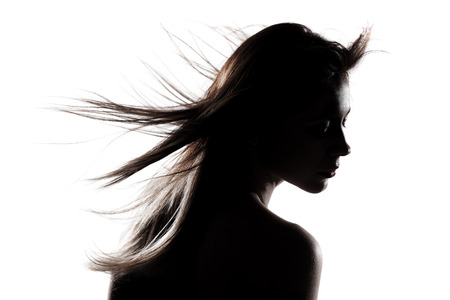 silhouette portrait of a beautiful caucasian girl の写真素材