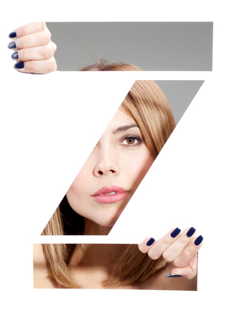 girl hiding behind and holding the letter "Z"の写真素材