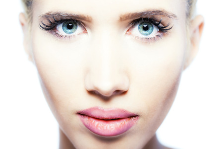 beautiful blond girl with blue eyes looking at camera, close up portraitの写真素材