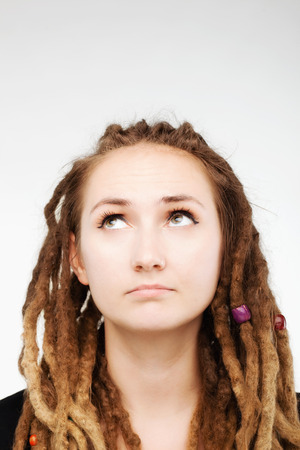 portrait of a caucasian girl with dreadlocks looking upの写真素材