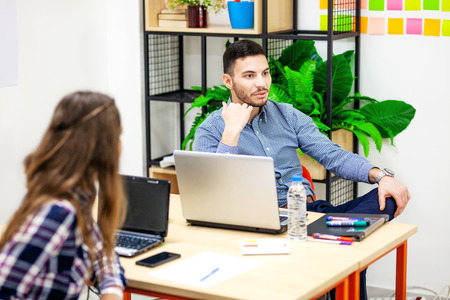 professor talking to young students in a modern classroom