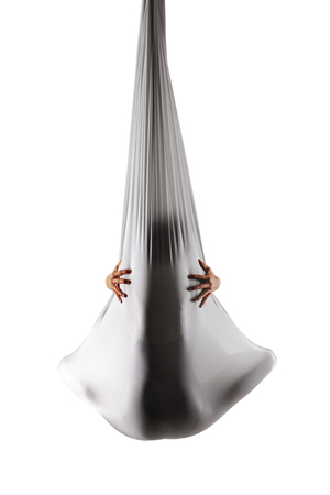 female posing aerial anti-gravity yoga on a hammockの写真素材