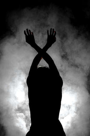 silhouette modern ballet dancer posing on dark background with smokeの写真素材