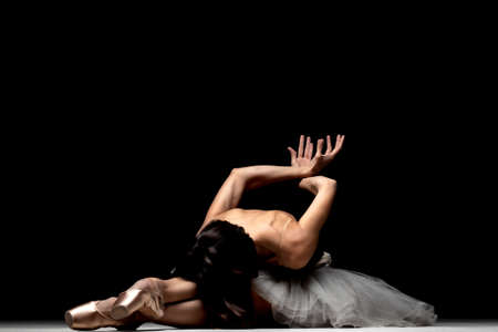 ballerina with a tutu posing on the floorの写真素材