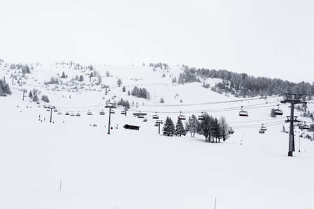 chair lifts in ski center les arcs, paradiski on the french alps on a winter snowy day