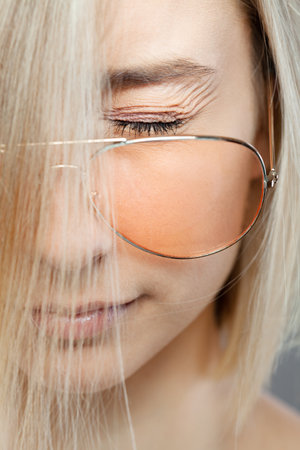 Portrait of a woman with glasses eyes closed.