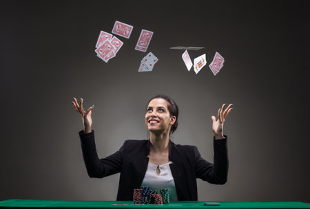 Girl playing poker. Throwing cards in the air.
