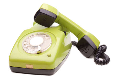 Green telephone retro style on white background. Vintage phone handset receiver.の写真素材