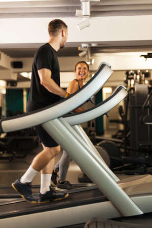 Couple working out on a treadmil in a fitness clubの写真素材