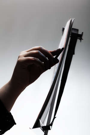 Artist drawing with chalk. Abstract hand painting on paper against gray background.の写真素材