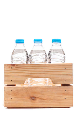 Group of small plastic water bottles in wooden crate. Studio photo isolation.の写真素材
