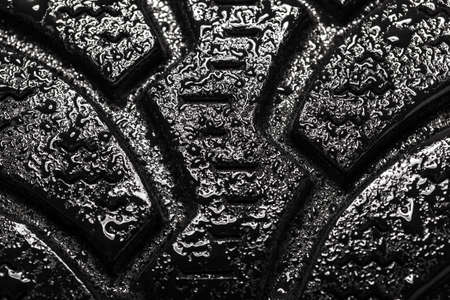 Abstract wet car winter tire. Rubber tyre cover patern with water drops.の写真素材