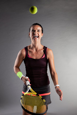 Professional female tennis player. Girl swinging racket.の写真素材