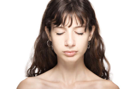 Beautiful young girl studio portrait. Eyes closed.