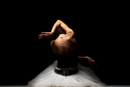 ballerina with a tutu posing on the floorの写真素材